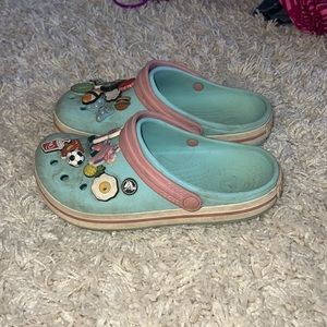 Blue and pink crocs with gibits